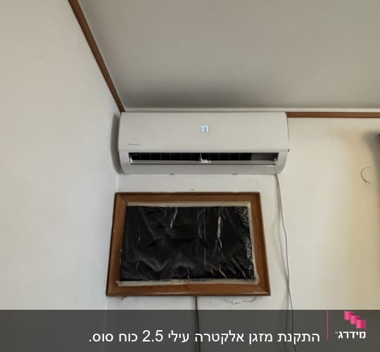 מזגן מותקן על קיר בחדר עם וילון